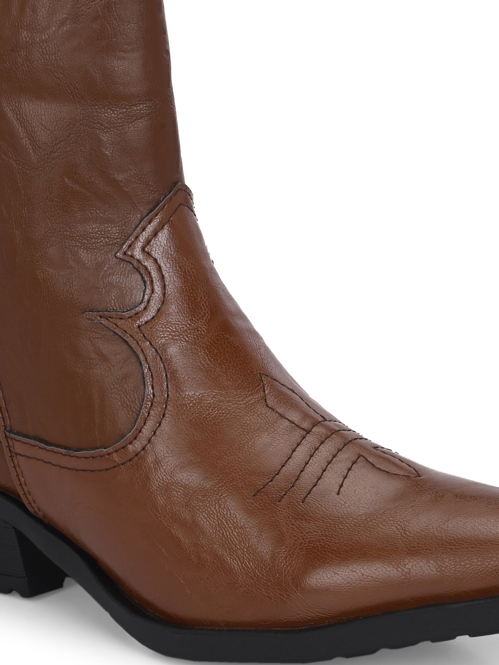 Tan ankle boots with intricate decorative stitching, featuring a slip-on design.