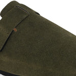 Olive suede slip-on clog with a black rubber sole and adjustable strap.