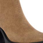 Glossy black patent leather ankle boot with a chunky block heel, lug sole, and a gold logo detail near the collar.