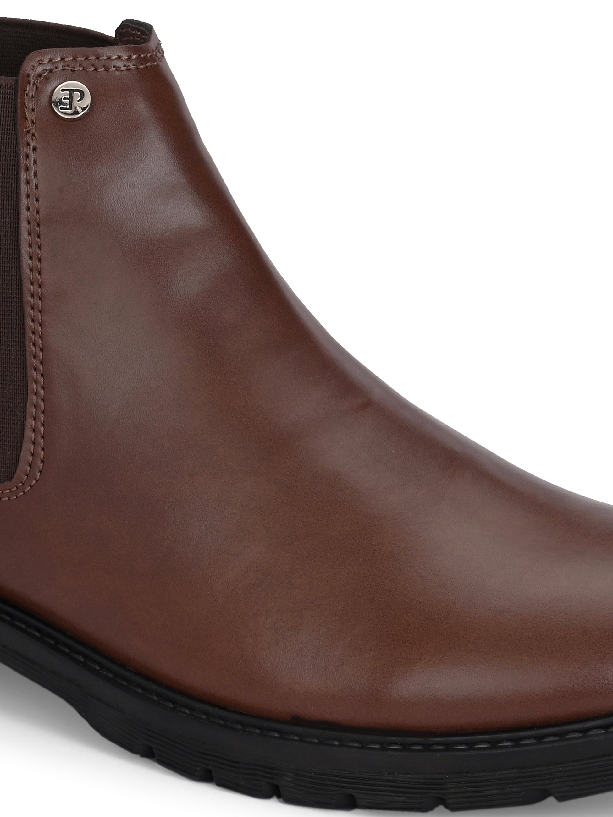 Brown Chelsea boots with elastic side panels, a pull-tab at the heel, rounded toe, and a small metallic brand logo near the ankle.