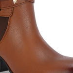Brown leather ankle boots with studded straps and a buckle design.
