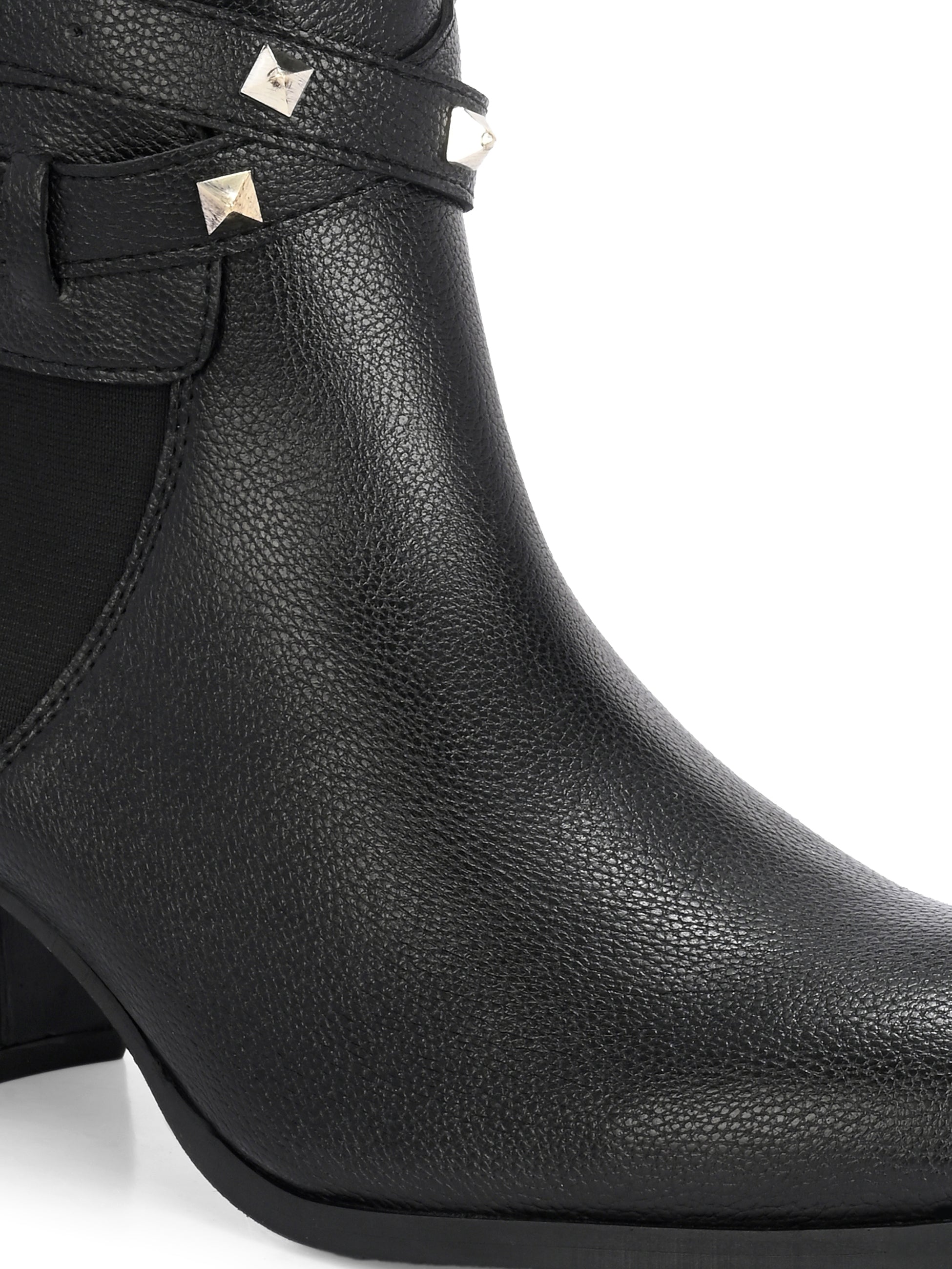 Black leather ankle boots with studded straps and a buckle design.