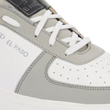 A white and grey sneaker featuring a sleek design and a clean white sole, perfect for casual wear.