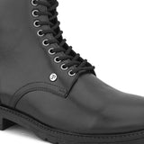 A sleek black patent leather Chelsea lace-up boot with a side zipper, pull-tab at the back, and a low block heel.