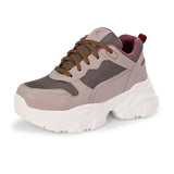 A chunky sneaker with a brown mesh upper, pink leather panels, brown laces, and a thick white sole.