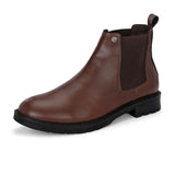 Brown Chelsea boots with elastic side panels, a pull-tab at the heel, rounded toe, and a small metallic brand logo near the ankle.