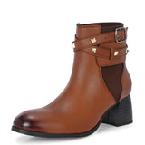 Brown leather ankle boots with studded straps and a buckle design.