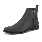 A sleek black leather Chelsea boot with a side zipper, pull-tab at the back, and a low block heel.