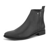 A sleek black leather Chelsea boot with a side zipper, pull-tab at the back, and a low block heel.