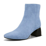 Light blue suede ankle boots with a sleek design and block heel.