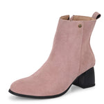 Light pink heigh top boot with a block heel and a sleek, minimalist design.