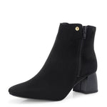 Suede ankle boot with pointed toe, chunky block heel, side zipper, and gold logo detail near the top.