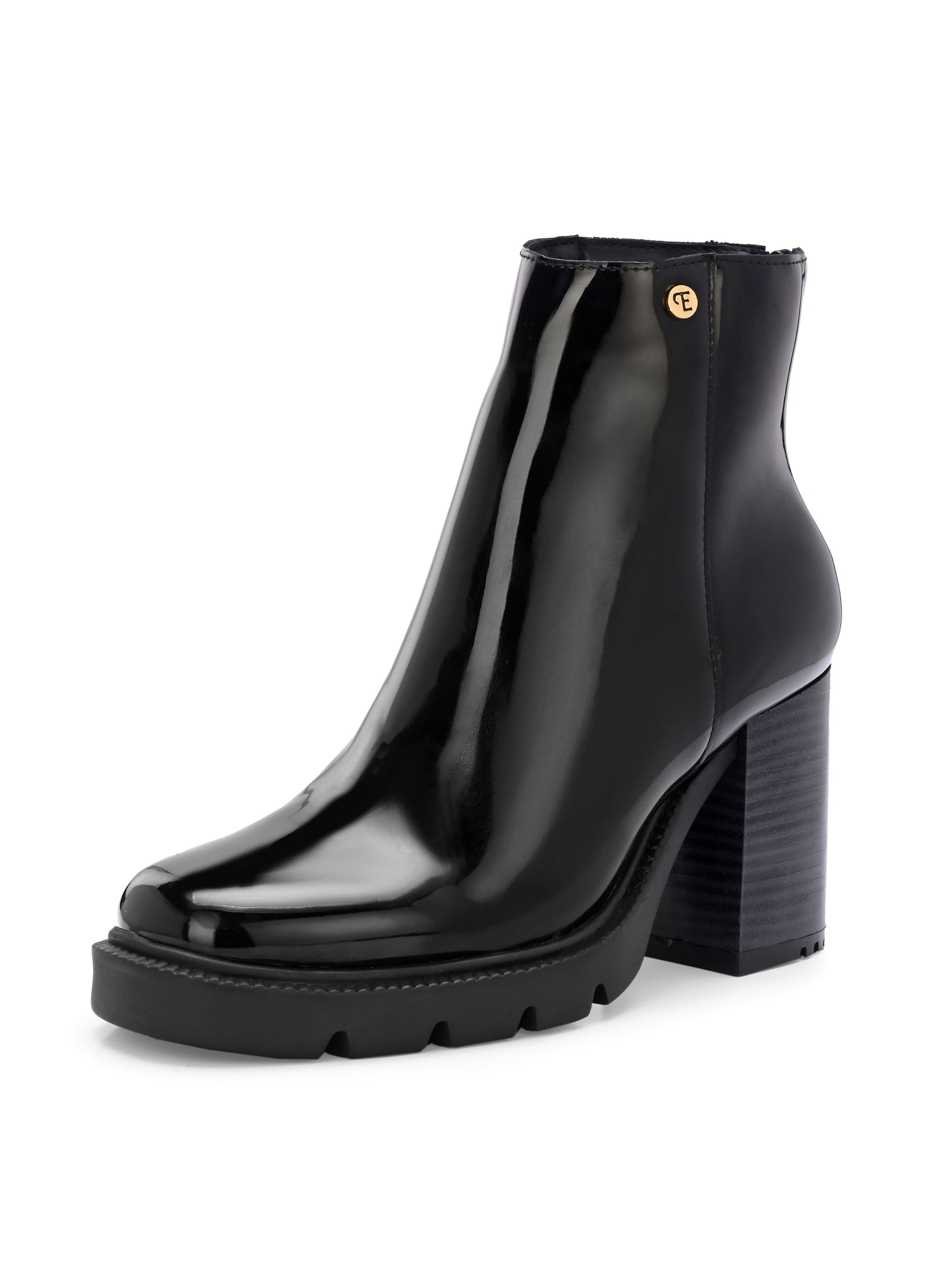 Glossy black patent leather ankle boot with a chunky block heel, lug sole, and a gold logo detail near the collar.