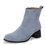 Light blue heigh top boot with a block heel and a sleek, minimalist design.