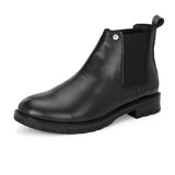 Classic Chelsea boots with elastic side panels, a pull-tab at the heel, rounded toe, and a small metallic brand logo near the ankle.