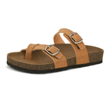 Brown cork-sole sandal with two adjustable straps featuring silver buckles and a casual slip-on design.
