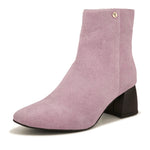 Light pink suede ankle boots with a sleek design and block heel.