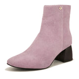 Light pink suede ankle boots with a sleek design and block heel.