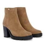 Glossy camel patent leather zip-closure ankle boot with a chunky block heel, lug sole, and a gold logo detail near the collar.