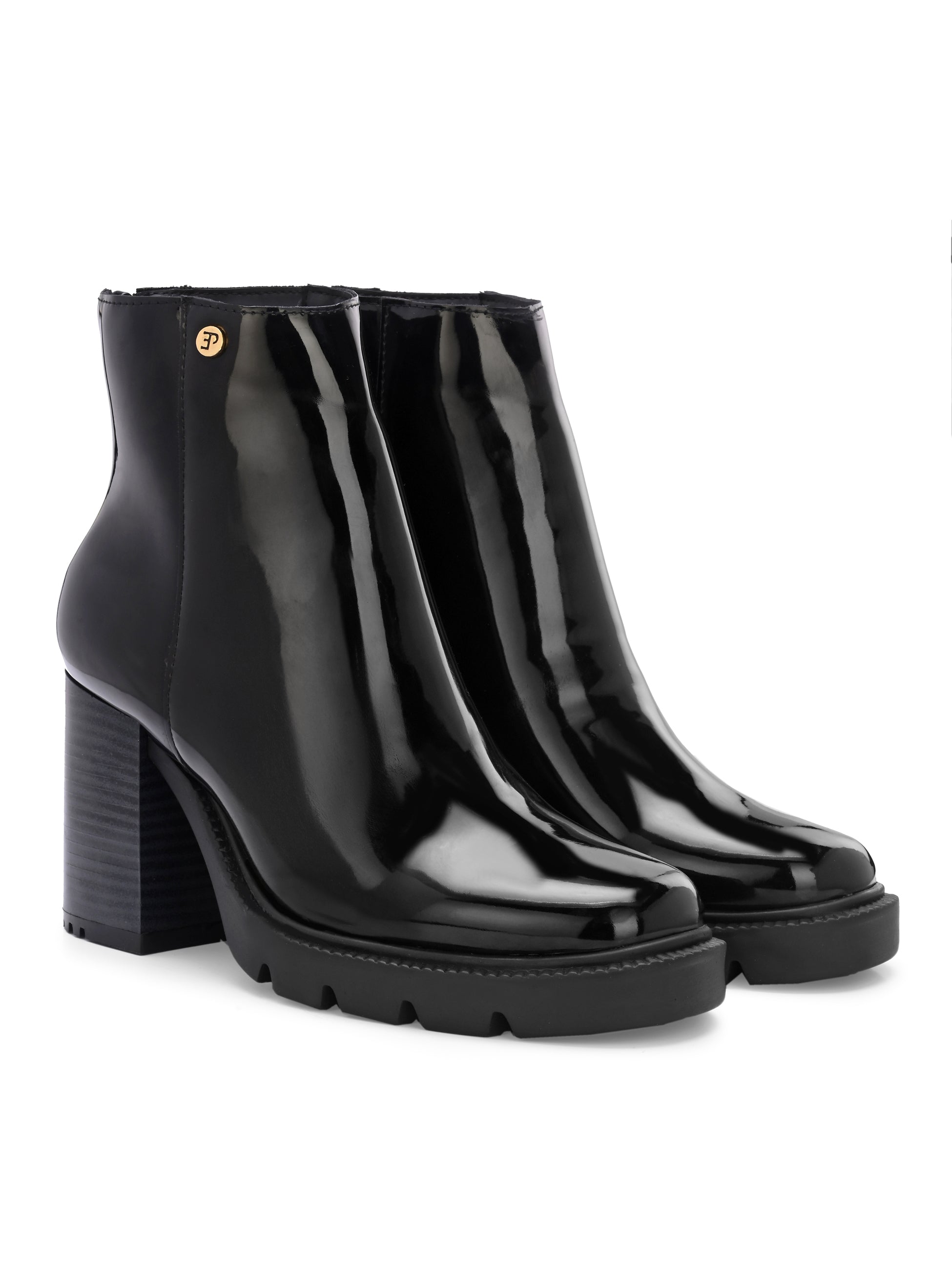 Glossy black patent leather zip-closure ankle boot with a chunky block heel, lug sole, and a gold logo detail near the collar.
