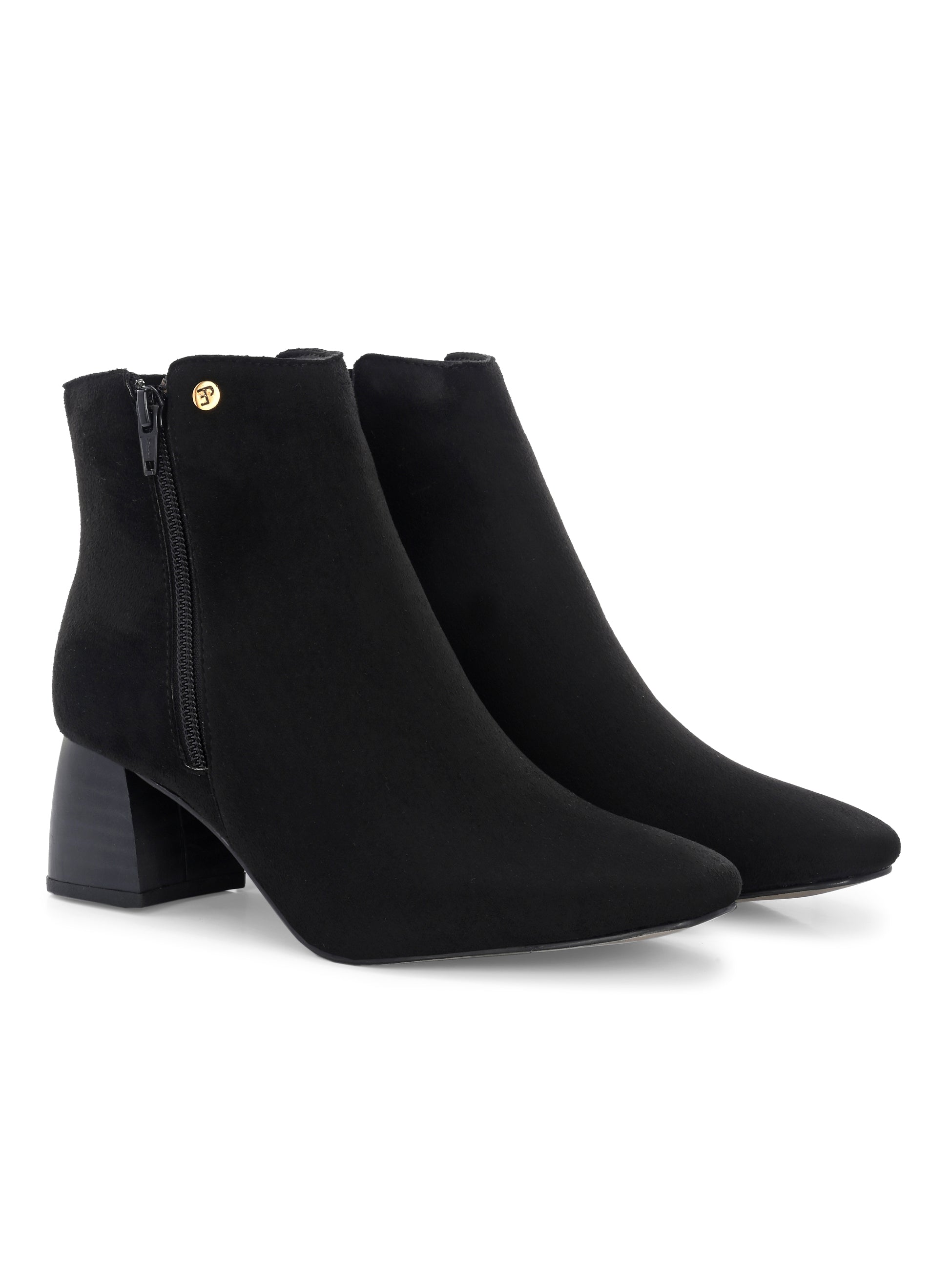 Suede ankle boot with pointed toe, chunky block heel, side zipper, and gold logo detail near the top.