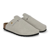 Nude suede slip-on clog with a black rubber sole and adjustable strap.