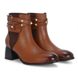 Women brown studded leather ankle boots with studded straps and a buckle design.