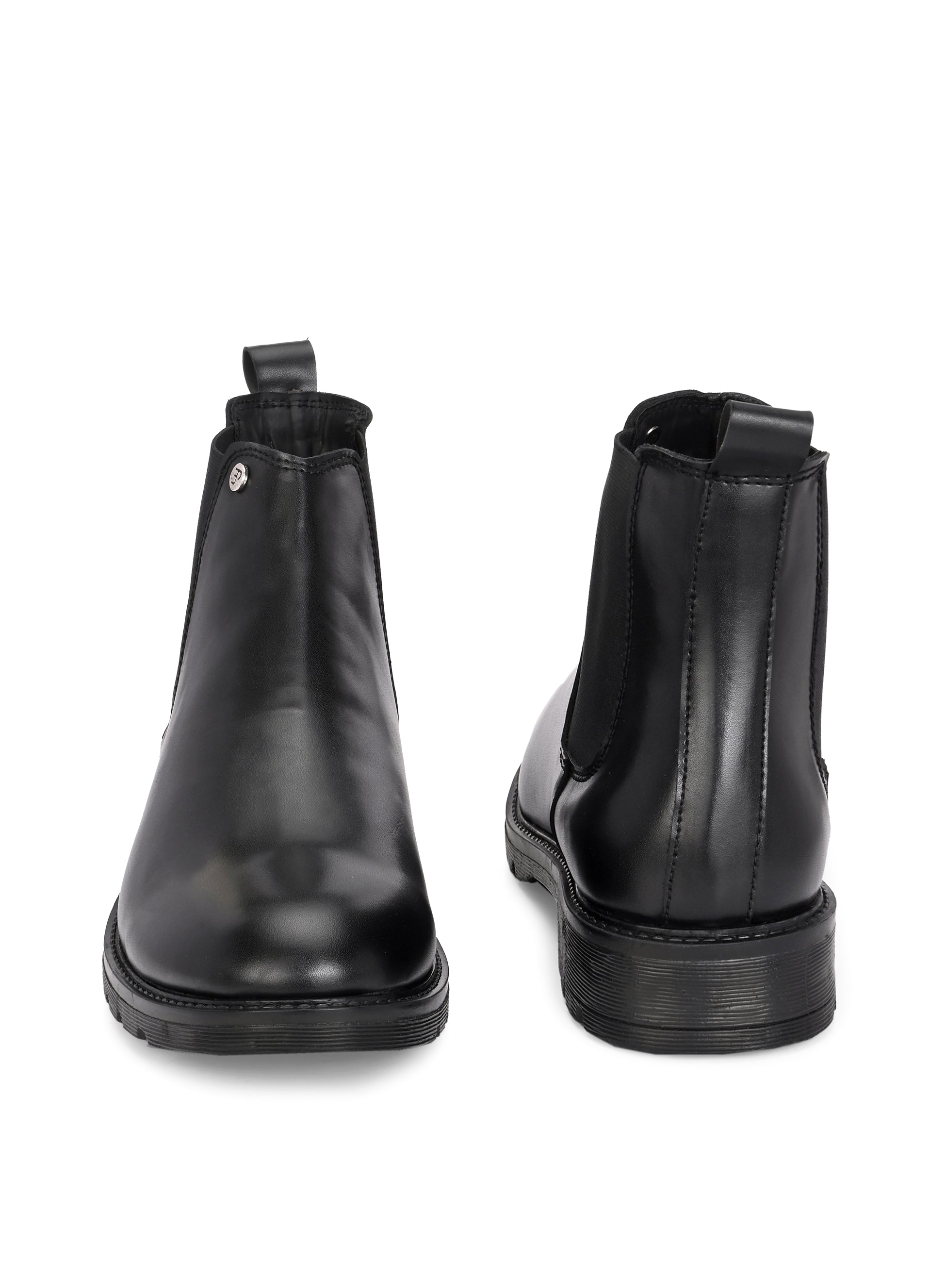 Classic Chelsea boots with elastic side panels, a pull-tab at the heel, rounded toe, and a small metallic brand logo near the ankle.
