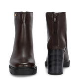 Glossy brown patent leather ankle boot with a chunky block heel, lug sole, and a gold logo detail near the collar.