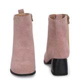 Light pink heigh top boot with a block heel and a sleek, minimalist design.