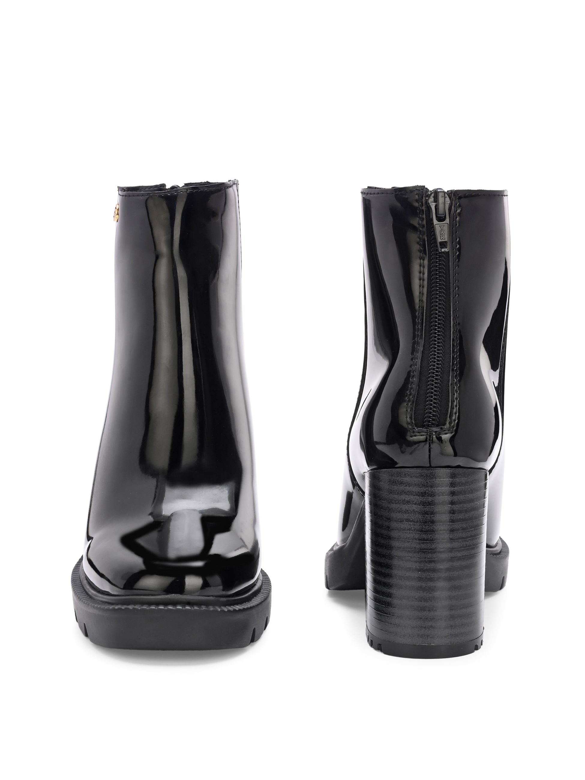 Glossy black patent leather ankle boot with a chunky block heel, lug sole, and a gold logo detail near the collar.
