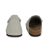 Nude suede slip-on clog with a black rubber sole and adjustable strap.