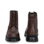 A sleek brown leather Chelsea lace-up boot with a side zipper, pull-tab at the back, and a low block heel.