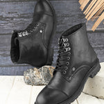 black lace up men boots with cap toe, silver eyelets, grooved rubber sole, and subtle brand logo near the ankle.