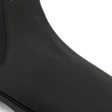 Black formal boots with a matte finish, elastic side panels, pull-tab, and a subtle metallic logo accent.