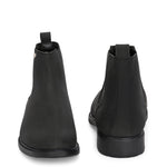 Black formal boots with a matte finish, elastic side panels, pull-tab, and a subtle metallic logo accent.