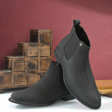 Black Chelsea boots with a matte finish, elastic side panels, pull-tab, and a subtle metallic logo accent.
