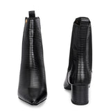 A stylish black ankle boot with a smooth leather finish, almond-shaped toe, mid-block heel, elastic side panel, and a gold accent logo.