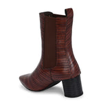 A stylish Tan ankle boot with a smooth leather finish, almond-shaped toe, mid-block heel, elastic side panel, and a gold accent logo.