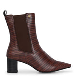 A stylish Tan ankle boot with a smooth leather finish, almond-shaped toe, mid-block heel, elastic side panel, and a gold accent logo.