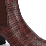 A stylish Tan ankle boot with a smooth leather finish, almond-shaped toe, mid-block heel, elastic side panel, and a gold accent logo.