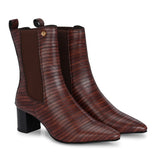 A sleek Tan crocodile-textured ankle boot with a pointed toe and mid-block heel, featuring an elastic side panel and a gold accent logo.