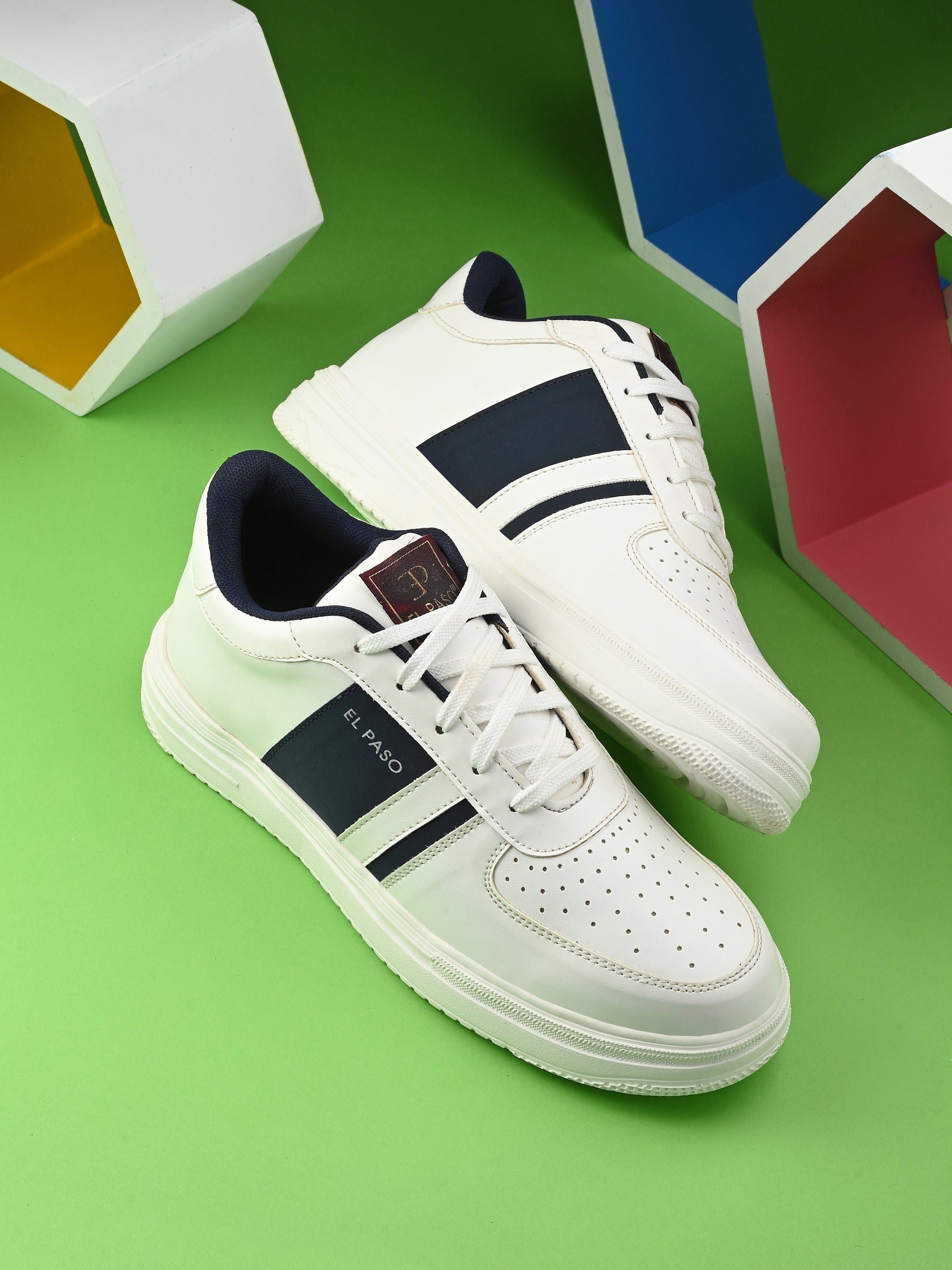 Men's Leather Casual Lace-Up Sneaker in white with navy blue stripe, perforated toe detail, and lightweight rubber sole.
