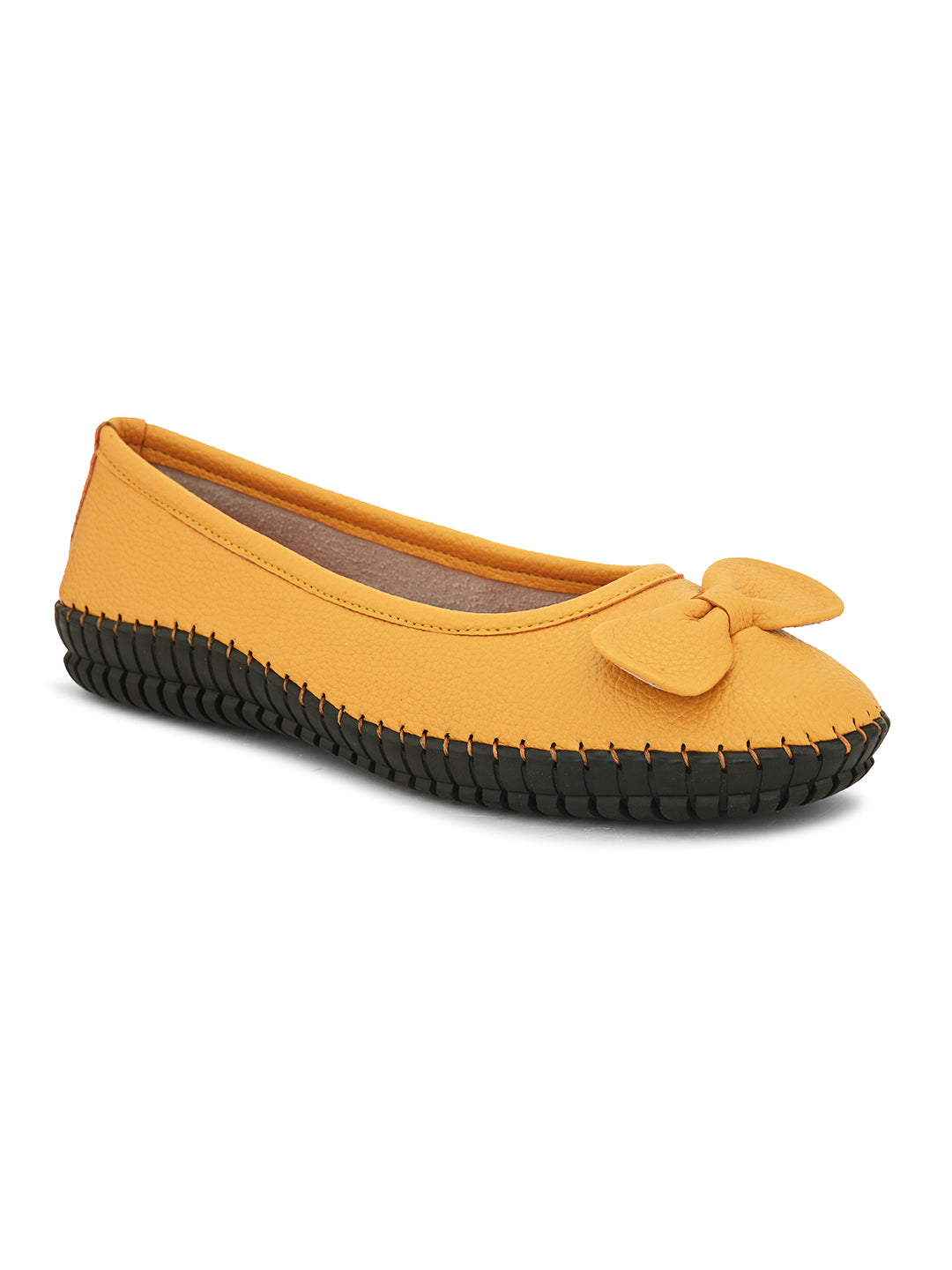 Mustard yellow leather Women Ballerina Flats with a decorative bow, black textured sole, and visible stitching for a casual, stylish look.
