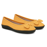 Mustard yellow leather Women Ballerina Flats with a decorative bow, black textured sole, and visible stitching for a casual, stylish look.