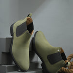 Olive formal boots with a matte finish, elastic side panels, pull-tab, and a subtle metallic logo accent.