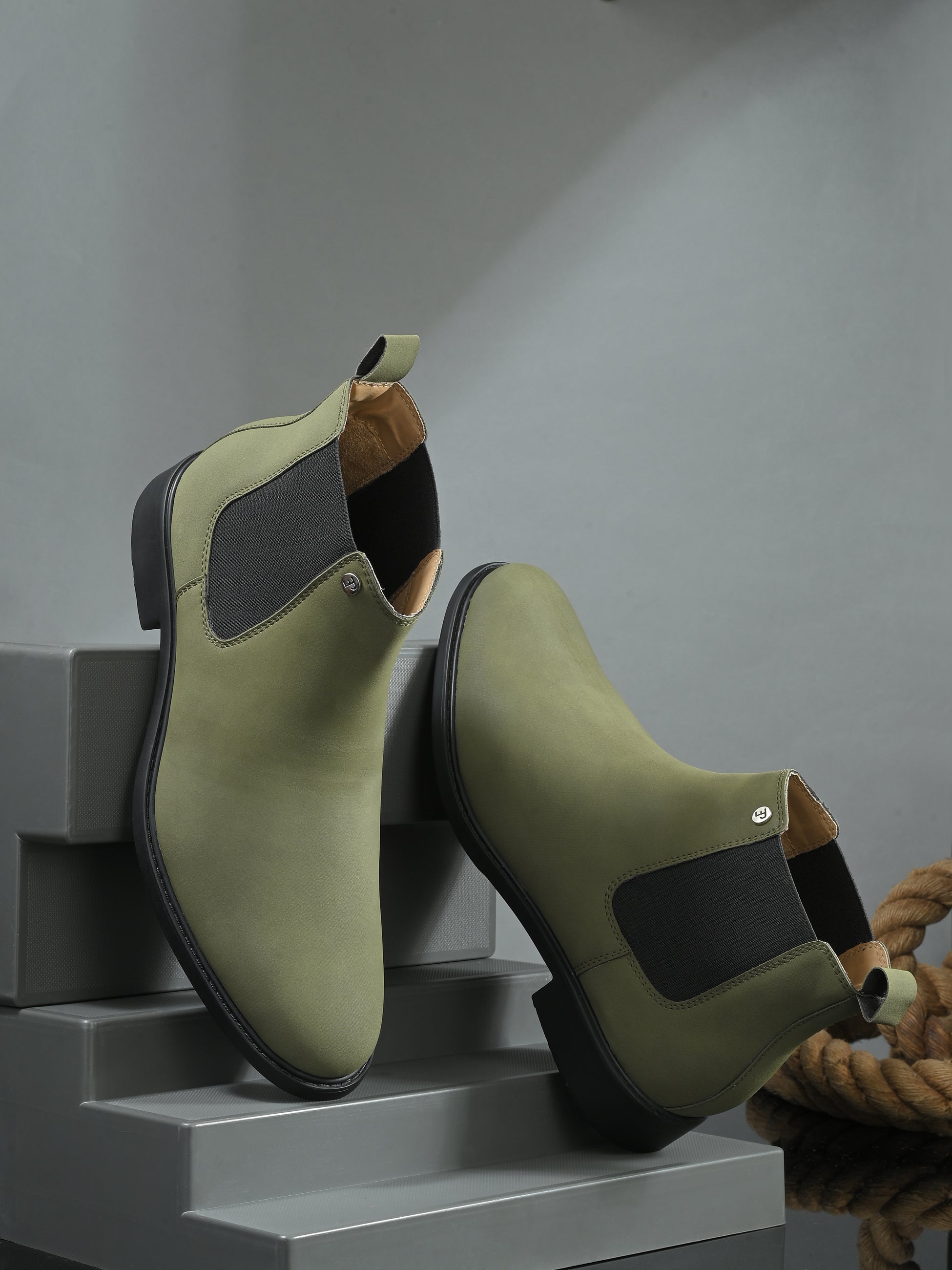Olive formal boots with a matte finish, elastic side panels, pull-tab, and a subtle metallic logo accent.