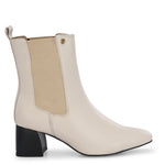 beige ankle boot with a smooth leather finish, elastic side panels, pull-tab, block heel, and pointed toe.