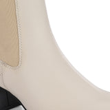 beige ankle boot with a smooth leather finish, elastic side panels, pull-tab, block heel, and pointed toe.