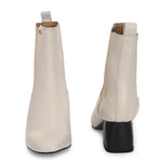 beige ankle boot with a smooth leather finish, elastic side panels, pull-tab, block heel, and pointed toe.